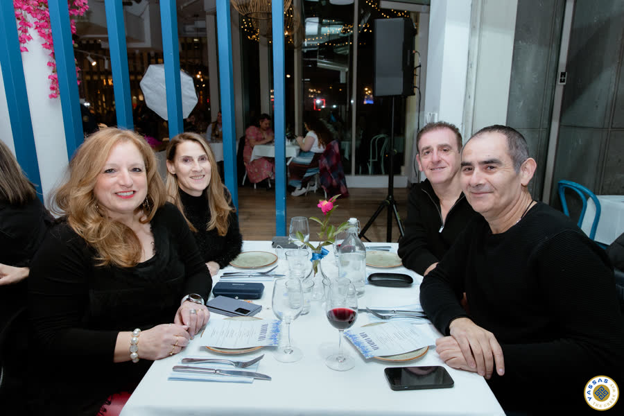 Dressed-up guests enjoying Greek feast at Mamma Mia Night Yassas